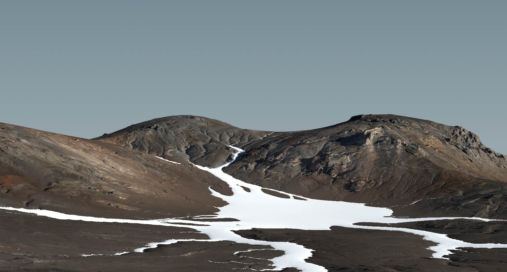 Wide view of dark volcanic ridges with snow fields between them